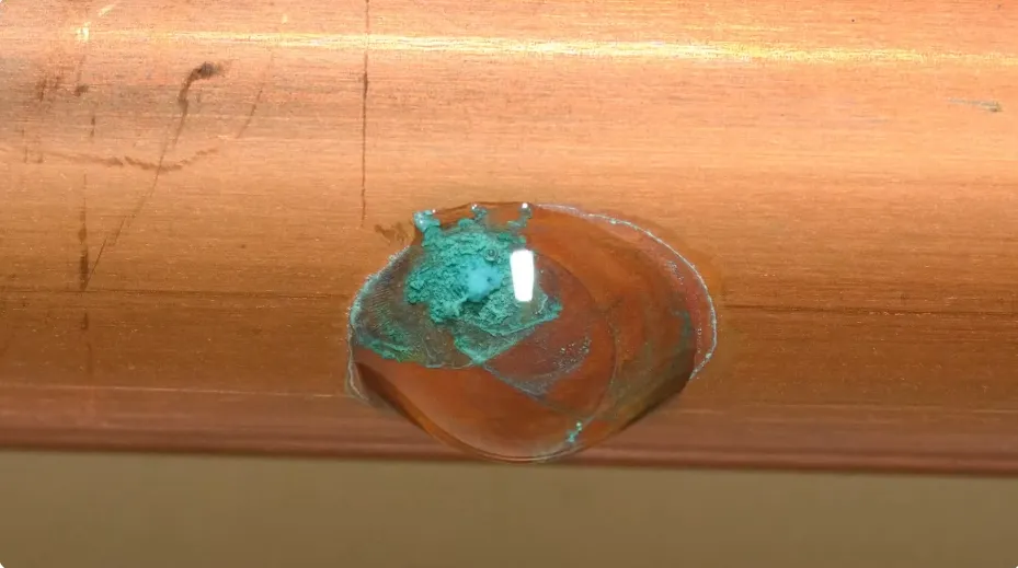 Corroded section of water pipe with a pinhole leak