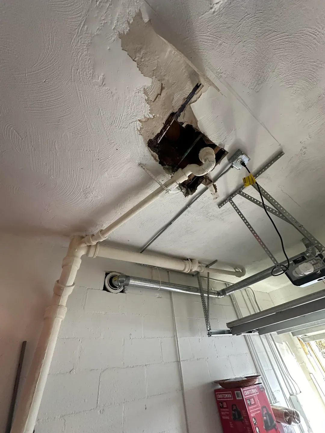 Drain pipe running through a garage ceiling